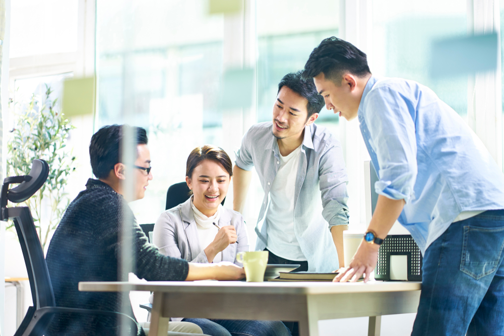 Group,Of,Four,Happy,Young,Asian,Corporate,Executives,Working,Together