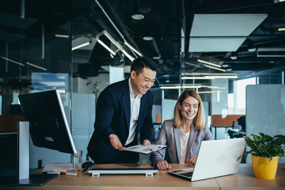 Two,Employees,In,A,Modern,Office,,An,Asian,Man,And