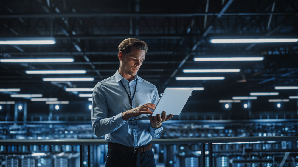 Portrait,Of,It,Specialist,Uses,Laptop,In,Data,Center.,Server